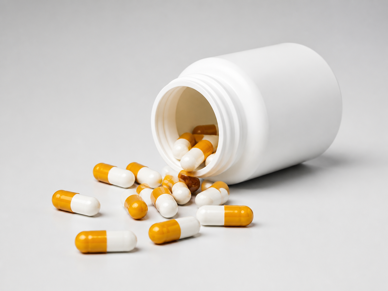 Dietary supplement capsules in an open bottle